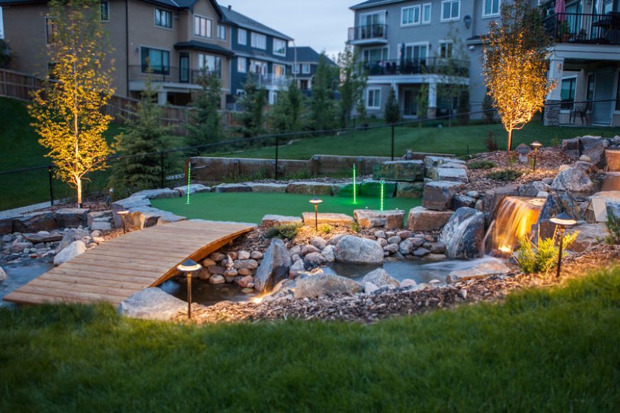 a putting course over a water path in a backyard